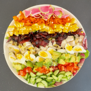 There’s something timeless about a well-made Cobb salad—the kind that hits every note: crunchy lettuce, juicy tomatoes, crispy bacon, creamy avocado, and perfectly jammy eggs. But what really sets this version apart is the dressing. Instead of the usual vinaigrette or blue cheese, we’re shaking things up with a sweet onion dressing that’s smooth, tangy, and just a little unexpected. It’s the kind of bold, balanced flavor that pulls the whole plate together and makes you crave the next bite. Whether you’re serving it for lunch, prepping ahead for the week, or plating it up for guests, this Cobb salad isn’t just fresh—it’s elevated.